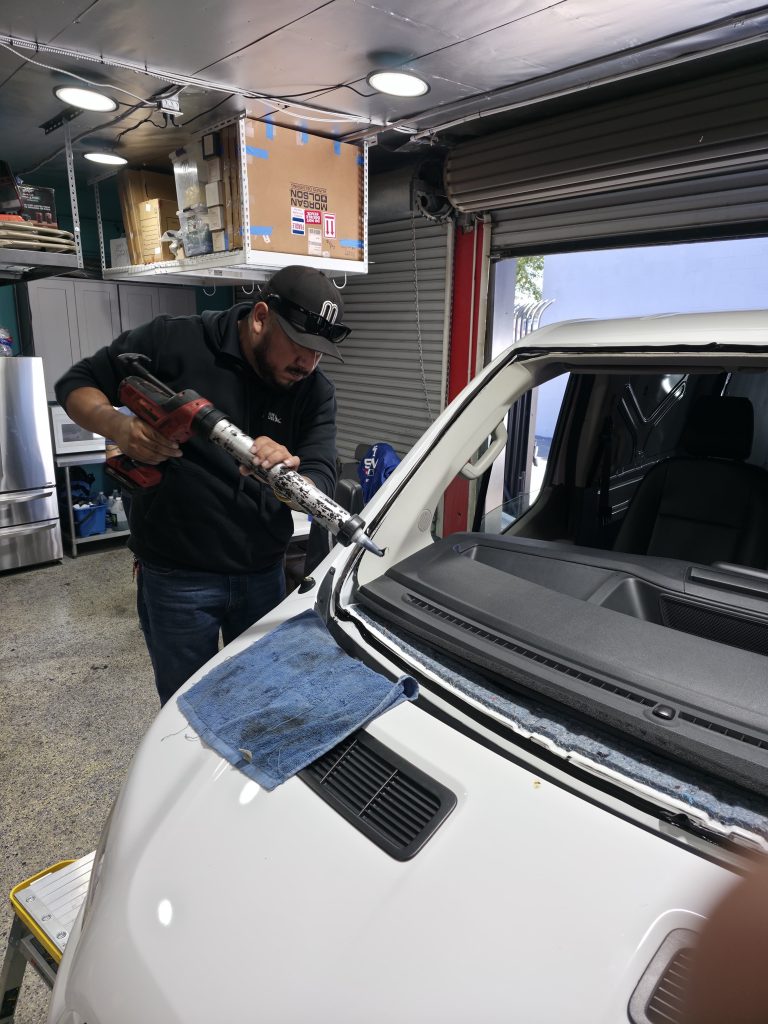 Technician performing windshield replacement at an auto glass shop serving Irvine, CA